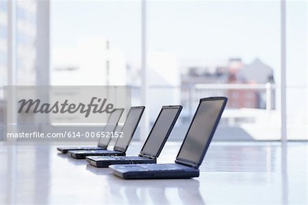 Row of laptops on a desk