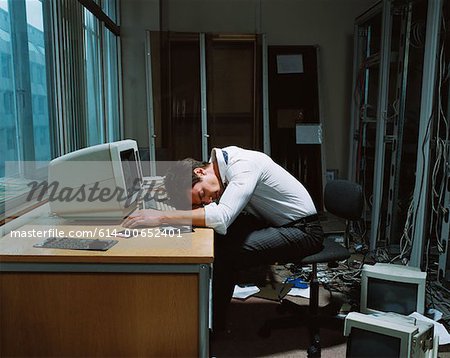 Office worker slumped on his desk
