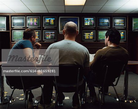 Three men in a betting shop