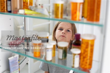 Boy Looking in Medicine Cabinet