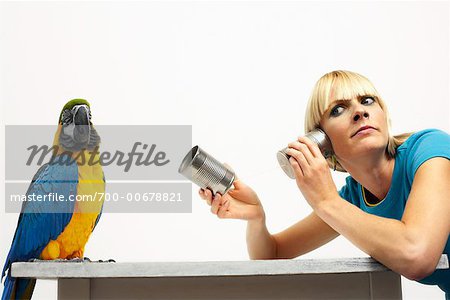 Woman Offering Blue and Yellow Macaw Tin Can Telephone