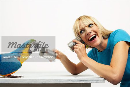 Woman Offering Blue and Yellow Macaw Tin Can Telephone