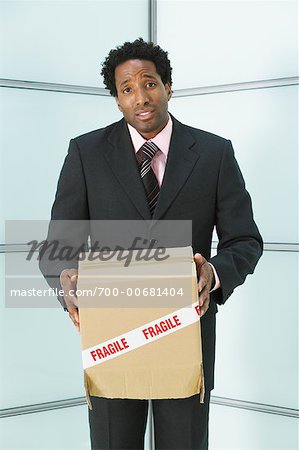 Businessman holding Box with Fragile Sticker on it