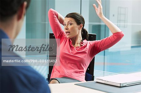Businesswoman with Underarm Perspiration Marks, Sitting at Desk
