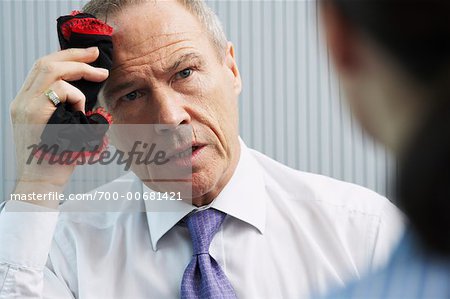 Businessman Wiping Forehead with Women's Underwear