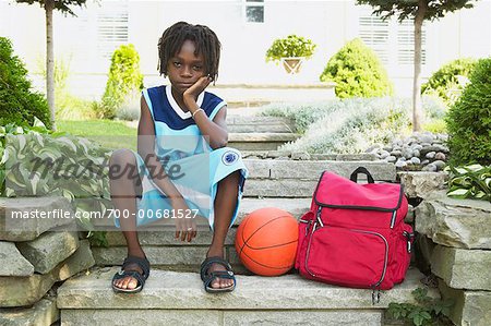 Unhappy Boy Sitting On Steps