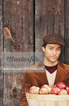 Portrait of Man Holding Basket of Apples