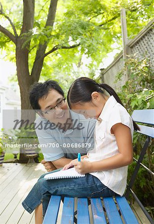 Father Watching Daughter Write