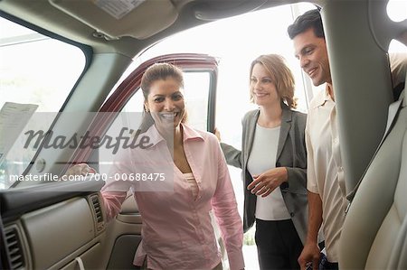 Car Saleswoman Talking to Clients