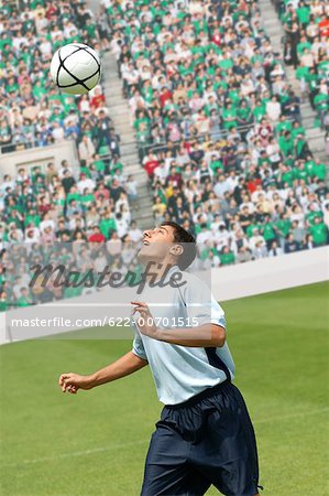 Soccer player juggling ball on head