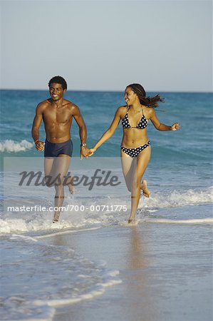 Cuban Couple Running Along Beach, Cuba