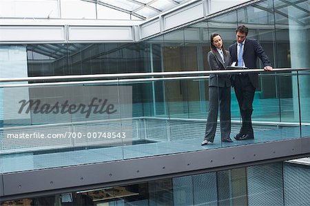 Business People Standing in Walkway of Office Building