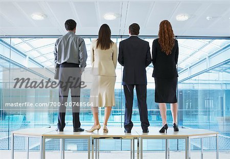 Back View of Business People Standing on Boardroom Table