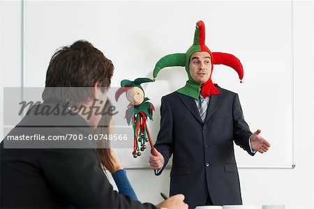 Businessman Holding Meeting in Jester Costume