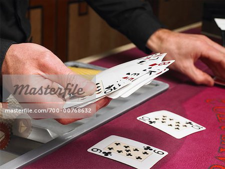 Close Up of Croupier Holding Cards