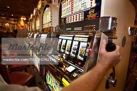 Person Playing Slot Machines at Casino, Las Vegas, Nevada, USA