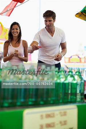 Couple Playing Game at Amusement Park