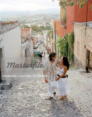 Couple Walking Up Cobblestone Street, Mexico