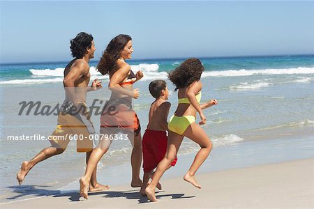 Family Running on the Beach