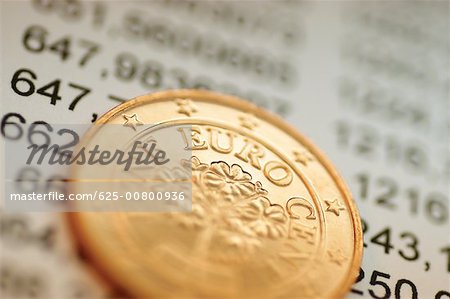 Close-up of Eurocent coin on financial figures Close-up of Eurocent coin on financial figures