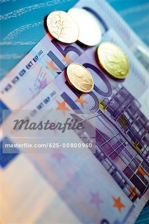 Close-up of Eurocent coins on Euro banknotes Close-up of Eurocent coins on Euro banknotes