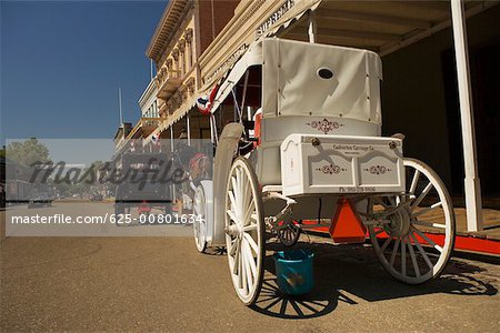 Two horse carts parked in front of a building