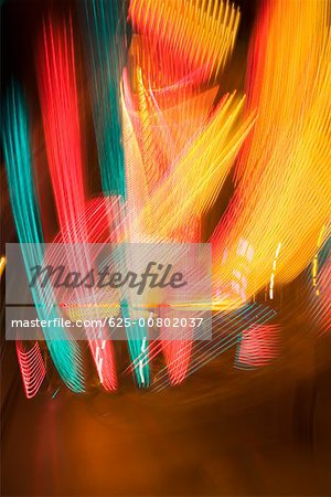 Lights glowing on a carnival ride at night, California, USA