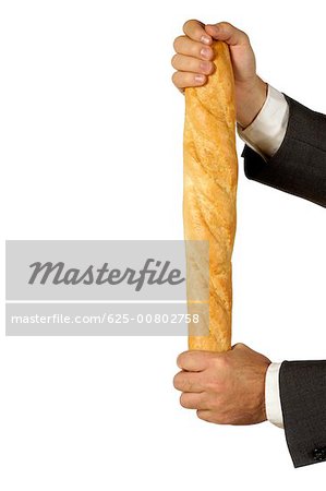 Close-up of a businessman holding a loaf of bread