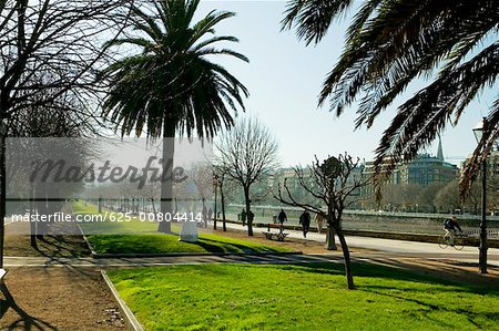 Group of people on the walkway by the river, Spain