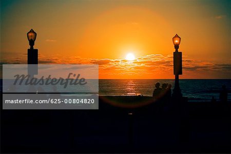 Silhouette of people on the beach at dusk, San Diego, California, USA