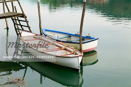 High angle view of two boats moored near a wooden pier, Spain