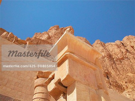 Low angle view of columns in front of a stone wall, Egypt