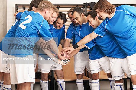 Football team putting hands together