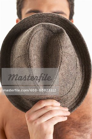 Man Covering Face with Hat