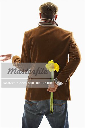Man Holding Flowers Behind Back