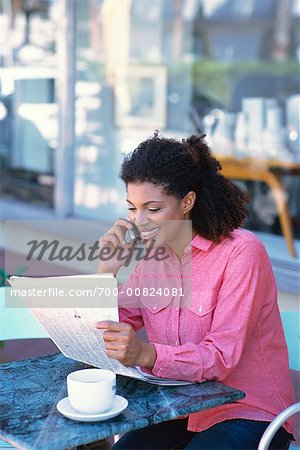 Woman with Cell Phone and Newspaper Outdoors