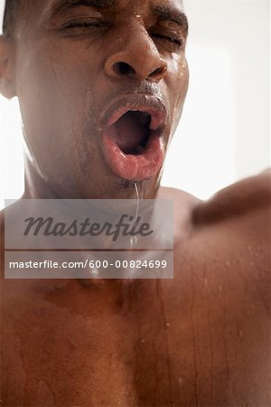 Man Splashing Water on Face