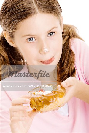 Portrait of a girl holding a donut licking her lips