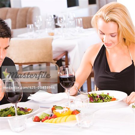 Mid adult man and a young woman sitting in a restaurant