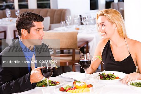 Mid adult man and a young woman sitting in a restaurant