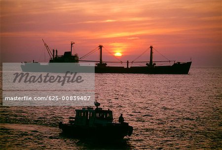 Freighter at sunset in the South China Sea, Vietnam