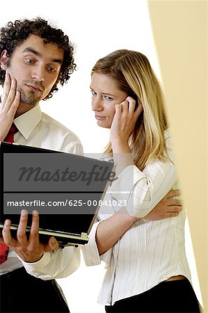 Businessman and a businesswoman looking at a laptop