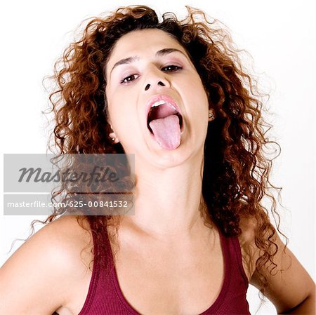 Close-up of a young woman sticking out her tongue