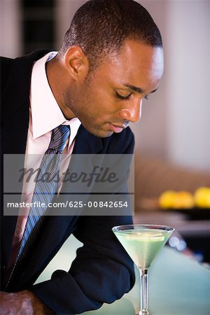 Nahaufnahme eines Kaufmanns, der Blick auf ein Glas martini