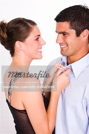 Side profile of a young woman and a mid adult man smiling