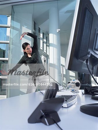 Woman on the phone and stretching