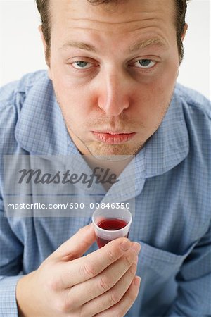 Man Holding Cough Syrup