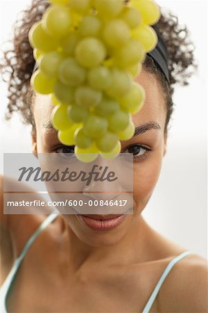 Woman Holding Bunch of Grapes