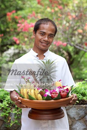 Portrait of Waiter With Bowl of Fruit