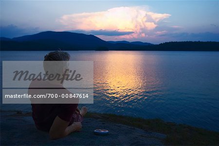 Man Watching Sunset Over Lake